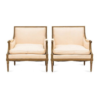 A Pair of Louis XVI Style Gilt Walnut and Upholstered Bergères